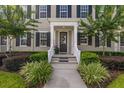 Inviting front porch with lush landscaping, decorative plants, and a welcoming entryway at 1845 Island Village Way, Celebration, FL 34747