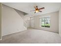 Bright living room with a ceiling fan and large window for natural light at 2050 Island Walk Dr, Orlando, FL 32824