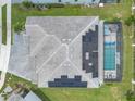 Aerial view of the home with solar panels and a screened in pool at 2417 Shanti Dr, Kissimmee, FL 34746
