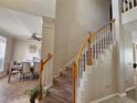 View of the carpeted staircase with views to the dining room at 2735 Scarborough Dr, Kissimmee, FL 34744