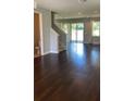 Open-concept living room with hardwood floors and sliding glass doors to the backyard at 2813 Roseglen Way, Orlando, FL 32812