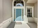 A close-up of the inviting blue front door with decorative windows and trim at 2924 White Cedar Cir, Kissimmee, FL 34741
