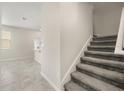 An interior view of a carpeted staircase, seamlessly connecting the different levels of the home at 2966 Aqua Virgo Loop # 16, Orlando, FL 32837