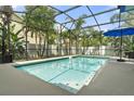 Relaxing screened-in pool area surrounded by tropical plants, perfect for enjoying the outdoors and recreation at 3310 Cat Brier Trl, Harmony, FL 34773