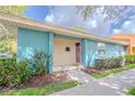 Inviting single-story villa featuring a covered entryway with landscaping and a well-maintained lawn at 4768 Tangerine Ave # 4768, Winter Park, FL 32792