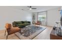 Bright living room features modern furnishings, sleek ceiling fan and a large window at 4768 Tangerine Ave # 4768, Winter Park, FL 32792