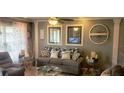 Cozy living room featuring a comfortable sofa, decorative wall art and neutral color scheme at 505 Oak Dr, Tavares, FL 32778