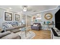 Inviting living room with stylish decor, hardwood floors, and comfortable seating arrangement at 505 Oak Dr, Tavares, FL 32778