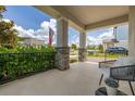 Inviting covered front porch with stone pillars, decorative railing, outdoor seating, and views of the neighborhood at 5133 Citrus Leaf Blvd, Winter Garden, FL 34787