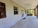 Covered patio with ceiling fans, brick columns, and an outdoor brick kitchen area, perfect for entertaining at 600 Lake Butler Ave, Osteen, FL 32764