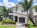 A charming two-story house with a modern design, beautiful stonework, and lovely landscaping at 661 Drop Shot Dr, Davenport, FL 33896