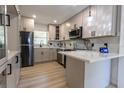 Modern kitchen with stainless steel appliances, stylish cabinetry, and marble countertops at 722 Carlson Dr, Orlando, FL 32804
