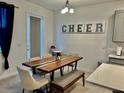 Bright dining room with a wooden table, cushioned chairs, and modern decorations at 775 Longboat Dr, Davenport, FL 33896