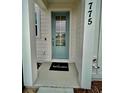 Inviting front entryway with a teal door and welcome mat at 775 Longboat Dr, Davenport, FL 33896
