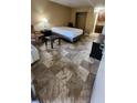 Cozy bedroom featuring tile flooring, a comfortable bed, and a well-equipped kitchenette at 7900 S Orange Blossom Trl # 2074, Orlando, FL 32809
