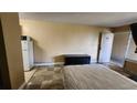 Functional bedroom featuring tile flooring, a comfortable bed, kitchenette, and ample space at 7900 S Orange Blossom Trl # 2074, Orlando, FL 32809