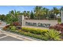 The Phillips Grove community entrance sign, surrounded by tropical landscaping and palm trees at 9071 Woodland Forest Rd, Orlando, FL 32836