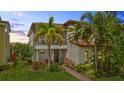 Charming two-story home featuring a cozy balcony and lush, tropical landscaping at 10067 Mere Pkwy, Orlando, FL 32832