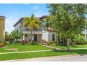 Charming two-story home featuring a cozy balcony and lush, tropical landscaping at 10067 Mere Pkwy, Orlando, FL 32832
