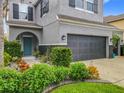 Well-maintained two story home featuring a large garage, manicured landscaping, and a blue front door at 12606 Old Plantation Ln, Orlando, FL 32824