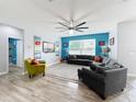 Spacious living room features modern decor, a ceiling fan, and a large sectional sofa at 12606 Old Plantation Ln, Orlando, FL 32824