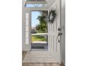 View of an open front door and sunlit walkway with views to the outside at 138 Hidden Pointe Ln, Groveland, FL 34736