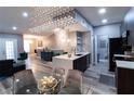 Open-concept dining area with elegant lighting, a modern island, and sleek furnishings, ideal for entertaining at 14205 Falls Church Dr # 2012, Orlando, FL 32837