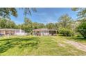 Charming single-story home with a well-maintained lawn and mature shade trees at 1431 Jack Calhoun Dr, Kissimmee, FL 34741