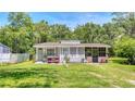 Charming single-story home with a well-maintained lawn and inviting porch seating at 1431 Jack Calhoun Dr, Kissimmee, FL 34741
