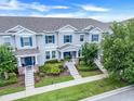 Attractive townhome showing well maintained landscaping, sidewalks, and inviting front entrances at 15540 Blackbead St, Winter Garden, FL 34787