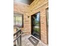 Brick walled entrance of a home featuring a 'Welcome' doormat at 1720 Foxhall Cir # 1720, Kissimmee, FL 34741