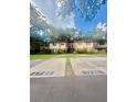 A two story residential building featuring private parking spots and staircases leading to each unit at 1720 Foxhall Cir # 1720, Kissimmee, FL 34741