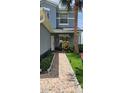Charming tiled entryway featuring a decorative walkway with welcoming plants and outdoor decor at 1827 Meadow Pond Way, Orlando, FL 32824