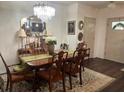 Elegant dining room with a chandelier, classic furniture, and stylish decor at 1868 Katz Crossing Dr, Kissimmee, FL 34744