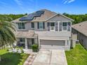 Charming two-story home with well-maintained landscaping, a palm tree, a covered porch and a two car garage at 209 Willow Bend Dr, Davenport, FL 33897