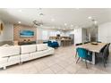 Open-concept living space featuring sleek furniture, a dining area, and a modern kitchen at 2161 Lelani Cir, Davenport, FL 33897