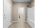 Well-lit mud room featuring tile floors, built-in storage, and an open doorway at 2161 Lelani Cir, Davenport, FL 33897