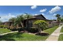 Well-kept single-story home featuring a neatly manicured lawn and palm trees at 2326 St Marteen Ct, Kissimmee, FL 34741
