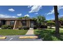 Inviting single-story home with a tidy front lawn and tropical landscaping at 2326 St Marteen Ct, Kissimmee, FL 34741
