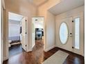 The entryway boasts hardwood floors and doors leading to bathroom and living spaces at 238 Sunridge Woods Blvd, Davenport, FL 33837