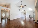 Spacious living room with hardwood floors, high ceilings, and a view of the kitchen at 238 Sunridge Woods Blvd, Davenport, FL 33837