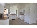 Spacious kitchen area with white cabinets, updated appliances, and lots of storage at 2401 Cedarfield Ln, Kissimmee, FL 34744