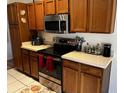 Efficient kitchen with stainless steel appliances and light countertops; ideal for meal preparation at 2704 Kendall Ave, Kissimmee, FL 34744