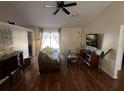 Open living room with hardwood floors, modern ceiling fan, and lots of natural light at 2704 Kendall Ave, Kissimmee, FL 34744