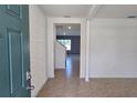 Inviting entryway featuring tile floors and modern textured walls, with an open view into the home at 2722 Numa Falls Ave, Davenport, FL 33837