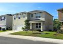 Corner lot home featuring a manicured lawn and an attached two-car garage at 2722 Numa Falls Ave, Davenport, FL 33837