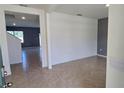 Open-concept living area featuring tile floors and neutral paint, creating a bright and airy space at 2722 Numa Falls Ave, Davenport, FL 33837