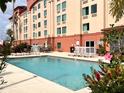 Outdoor pool featuring lounge chairs and tropical landscaping at 3000 Maingate Ln # 414, Kissimmee, FL 34747