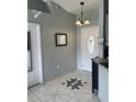 Welcoming foyer with decorative tile flooring and stylish lighting fixture at 306 Clermont Dr, Kissimmee, FL 34759