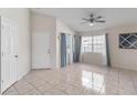 Bright living room featuring neutral walls, tile flooring, windows, and a ceiling fan at 3228 Fairfield Dr, Kissimmee, FL 34743